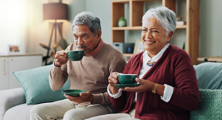 Canvas Print - Senior couple, happy and coffee on sofa in house, home and living room for retirement. People, elderly partners and family drinking tea, laughing and relax on couch for love, bonding and affection