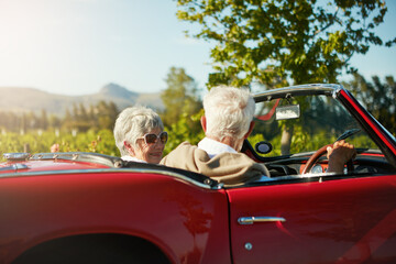 Canvas Print - Old couple, road trip and convertible car countryside driving in vineyard or retirement travel, marriage or adventure. Man, woman and transportation in Napa valley or exploring, nature or journey