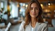 © VISUAL BACKGROUND - A woman in a white suit looking at the camera.