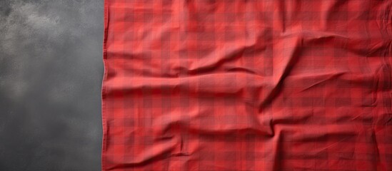 Aufkleber - A red checkered tablecloth lays on a dark stone surface providing a copy space image from a top view perspective