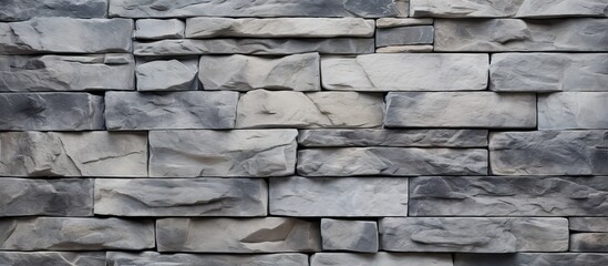 Aufkleber - A textured uneven gray stone wall serves as the backdrop for a simple rock blocks background The image contains copy space