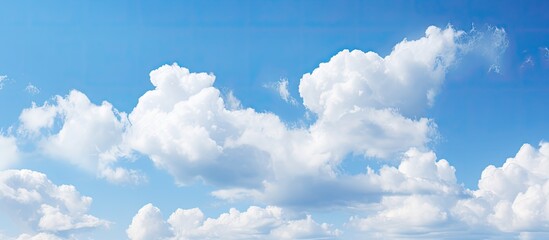 Fototapete - Clear blue skies with white fluffy clouds background copy space image