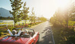 © peopleimages.com - Couple, convertible and hands up for road trip celebration or travel journey in California, transportation or vacation. Old people, retirement and morning adventure or vineyard, drive or countryside