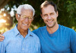 © peopleimages.com - Smile, man and senior father hug in portrait together outdoor for happiness on holiday or retirement. Family, grandfather and male person for bonding, care and support for elderly generation