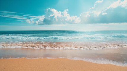 Wall Mural - A beautiful beach with a clear blue ocean and a few clouds in the sky