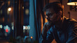 © VK Studio - Thoughtful man gazes out the window into the night, deep in contemplation.