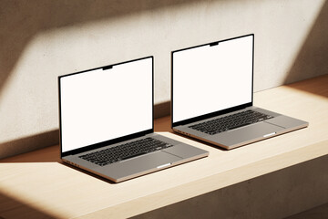 Wall Mural - two apple macbooks pro on the wooden desk on a plaster background