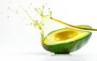 © bit24 - Avocado in oil splash flows  on white background. Exotic vegetables.
