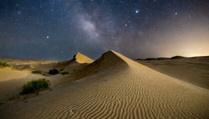 A desert landscape with towering sand dunes under a starlit sky.
