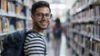 © LukaszDesign - Portrait of university, college, or academy library with student smiling for scholarship, research, learning, and knowledge. Study, education, creative geek with rucksack and school ambitions