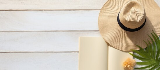 Poster - Summer beach accessories on a background with a blank writing book offering copy space Flat lay with additional space for text or images