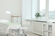 © New Africa - Modern interior of dermatologist's office with examination table