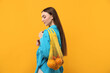 © New Africa - Woman with string bag of fresh oranges on orange background