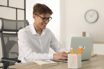 Poster - Man watching webinar at wooden table in office