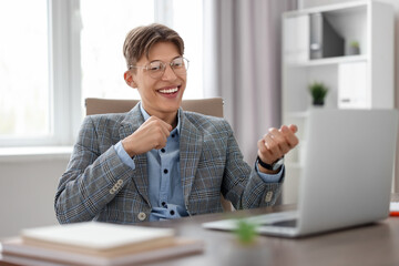 Poster - Man using video chat during webinar at wooden table in office