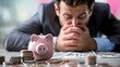 © vetrana - Businessman in debt holding piggy bank - concept of financial crisis and bankruptcy
