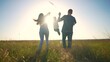 © maxximmm - Sunset silhouette of the family is running. happy family kid dream concept. The family run the park together. parents and kid are running across a field in the park at sunset holding hands lifestyle
