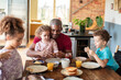© Marko Geber - Father having breakfast with children at home