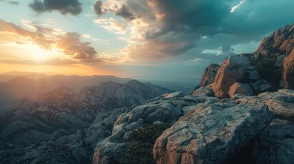 Wall Mural - Majestic sunset casting golden light over a rugged mountainous landscape, illuminating the textured rocks and valley