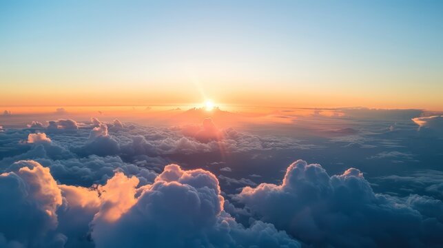 A stunning view of sunset above the cloud layer captured from the perspective of an airplane window