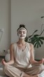 © spyrakot - Mindfulness Meditation with Calming Face Mask in Minimalistic Serene Space - Skincare and Mental Health Concept