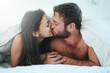 © peopleimages.com - Cover, morning and couple in bed with kiss, romance and happy bonding in apartment. Relationship, man and woman relax in bedroom with intimate embrace, passion and love with care on weekend in home