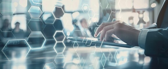 Digital business concept with a businessman's hand using a tablet computer and multiple hexagon shapes