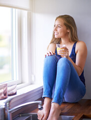 Canvas Print - Window, thinking and woman with juice at home for hydration, vitamin C and nutrition benefits. House, kitchen and girl with orange beverage for drinking, relax and weekend ideas or plans with smile