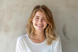 © BetterPhoto - Smiling woman with blonde hair wearing a white shirt against a light background with ample copy space