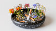 © Ritthichai - A black ashtray filled with colorful flowers and cigarette butts, symbolizing the contrast between beauty and pollution, nature and smoking.