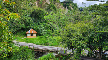 A small Islamic prayer room, or Musholla, is near the bridge in the middle of a fresh green forest. It is located near the Sianok Canyon, Bukittinggi, West Sumatera.