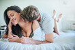 © peopleimages.com - Love, affection and couple in bed with romance, smile and morning bonding in apartment. Relationship, man and woman in bedroom with intimate embrace, passion and relax with care on weekend in home