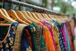 © olegganko - Row of Colorful Indian Sarees on Wooden Rack