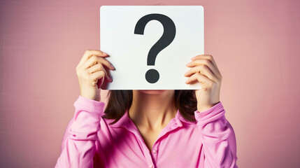 Wall Mural - A woman holding up an empty white card with the question mark symbol on it in front of her face