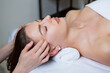 © Nomad Pixel - Beautiful young woman getting facial massage in spa salon. Beauty treatment concept.