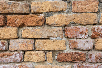 Sticker - Close up of an old weather wall of bricks with heavy texture.