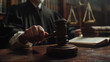 © PROKOPYCH - Judge's hand holding a gavel in a courtroom setting