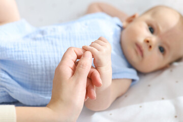 Wall Mural - Mother with her cute little baby in crib, selective focus