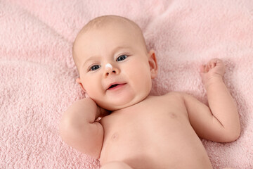 Canvas Print - Cute little baby with cream on nose on pink blanket, above view