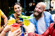 © Xavier Lorenzo - Young group of happy friends enjoying cocktail drink at bar terrace. Diverse young people having fun enjoying summer party during happy hour on summer vacation.