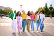 © CarlosBarquero - Group of young diverse only women friends walking relaxed and talking to each other and sharing a fun leisure time enjoying friendship together in city. Generation z youth community and people union