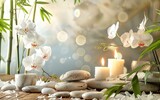 Serene spa setting with white orchids, candles, stones, and bamboo.