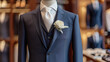 © Luluraschi - complete groom men's wedding suit with a white flower bud. in a modern sales hall or outfit rental salon