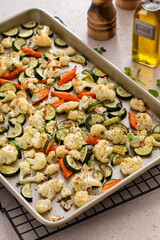 Wall Mural - Roasted vegetables on baking sheet with cauliflower, zucchini, and carrots