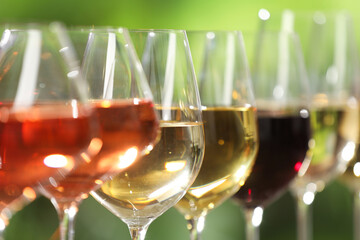 Poster - Different tasty wines in glasses against blurred background, closeup