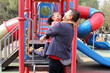 © Arlette - Divorced single dad plays with his brunette latina daughter in playground park spins and hugs spend fun time