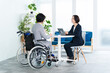 © taka - 車椅子に乗って働くビジネスウーマン