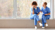 © Pixel-Shot - Female doctor calming her colleague in clinic