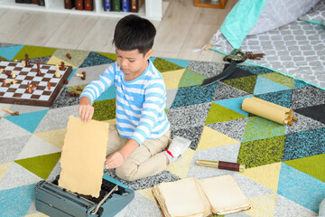 Poster - Cute little boy with typewriter at home