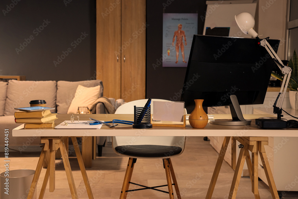 Nurse's workplace with computer at hospital in evening